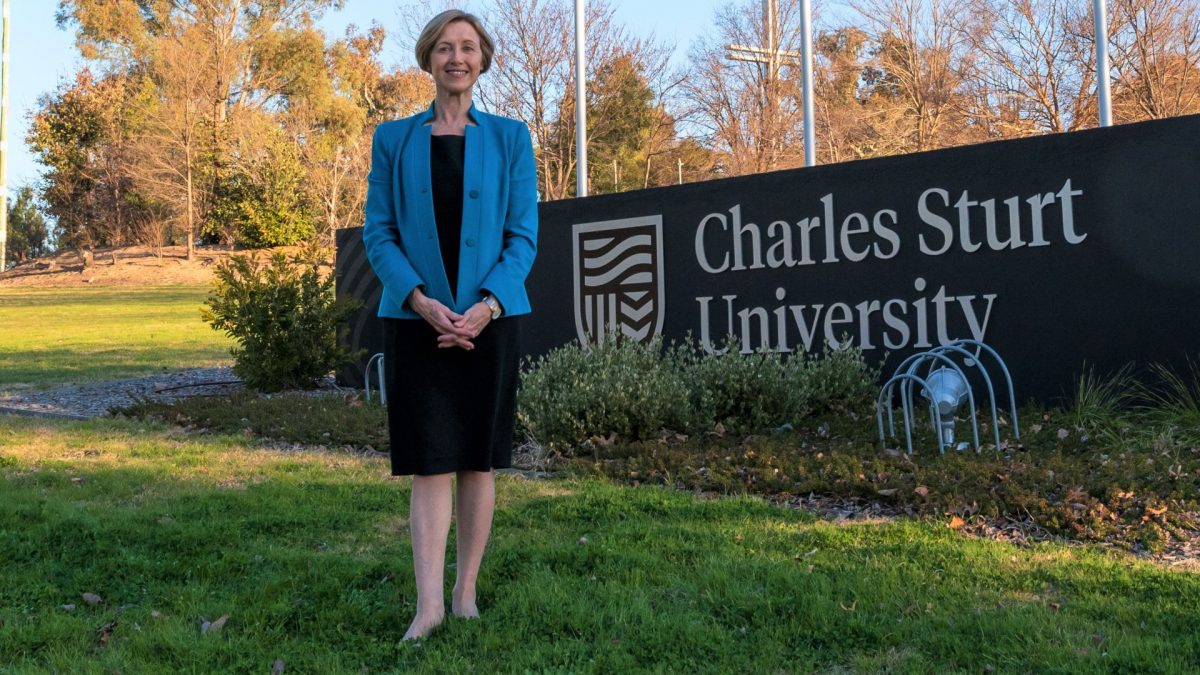 Renée Leon in front of Charles Sturt University sign