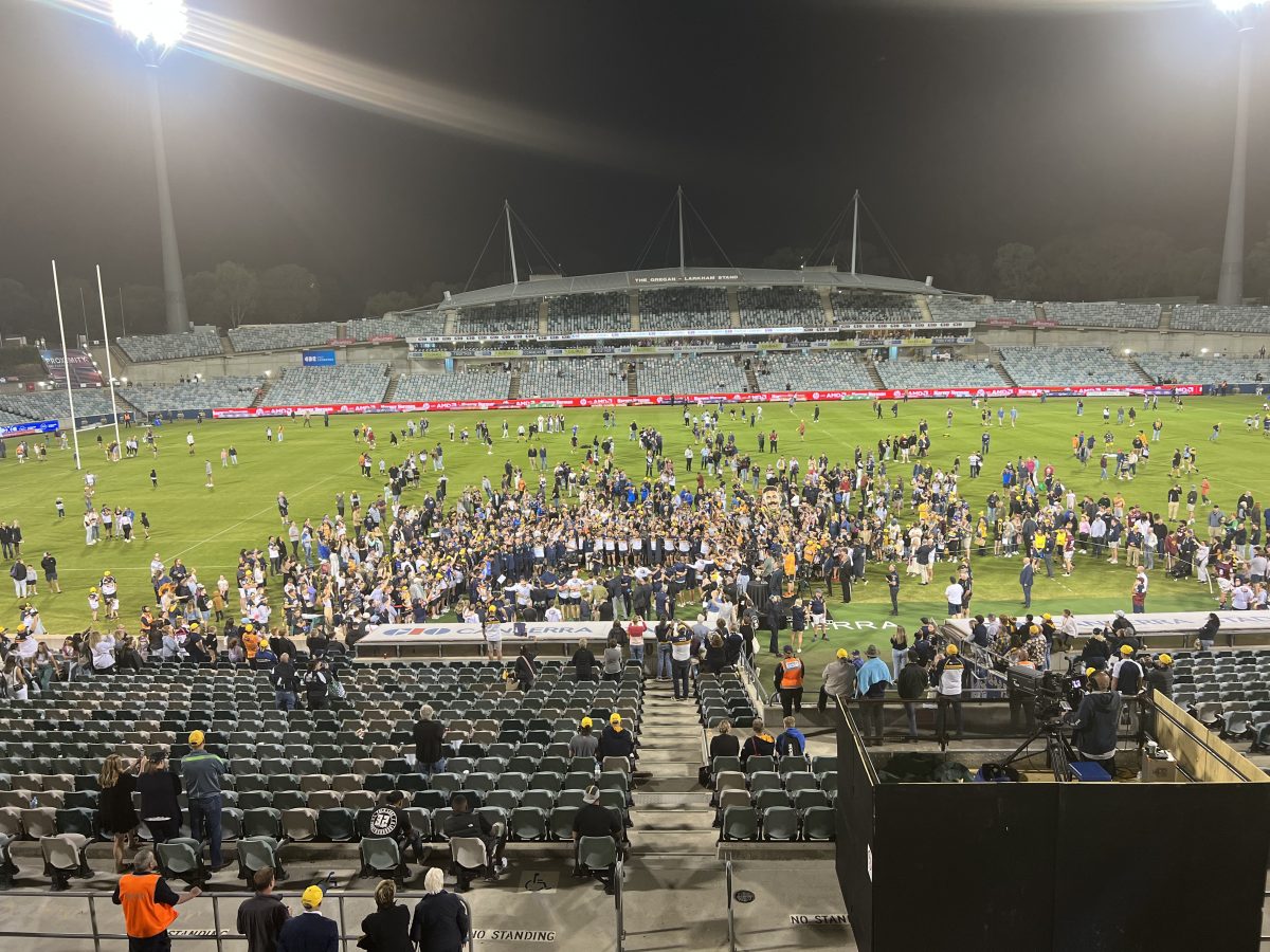 The Brumbies sing the team song surrounded by fans at GIO Stadium. Photo: Tim Gavel.