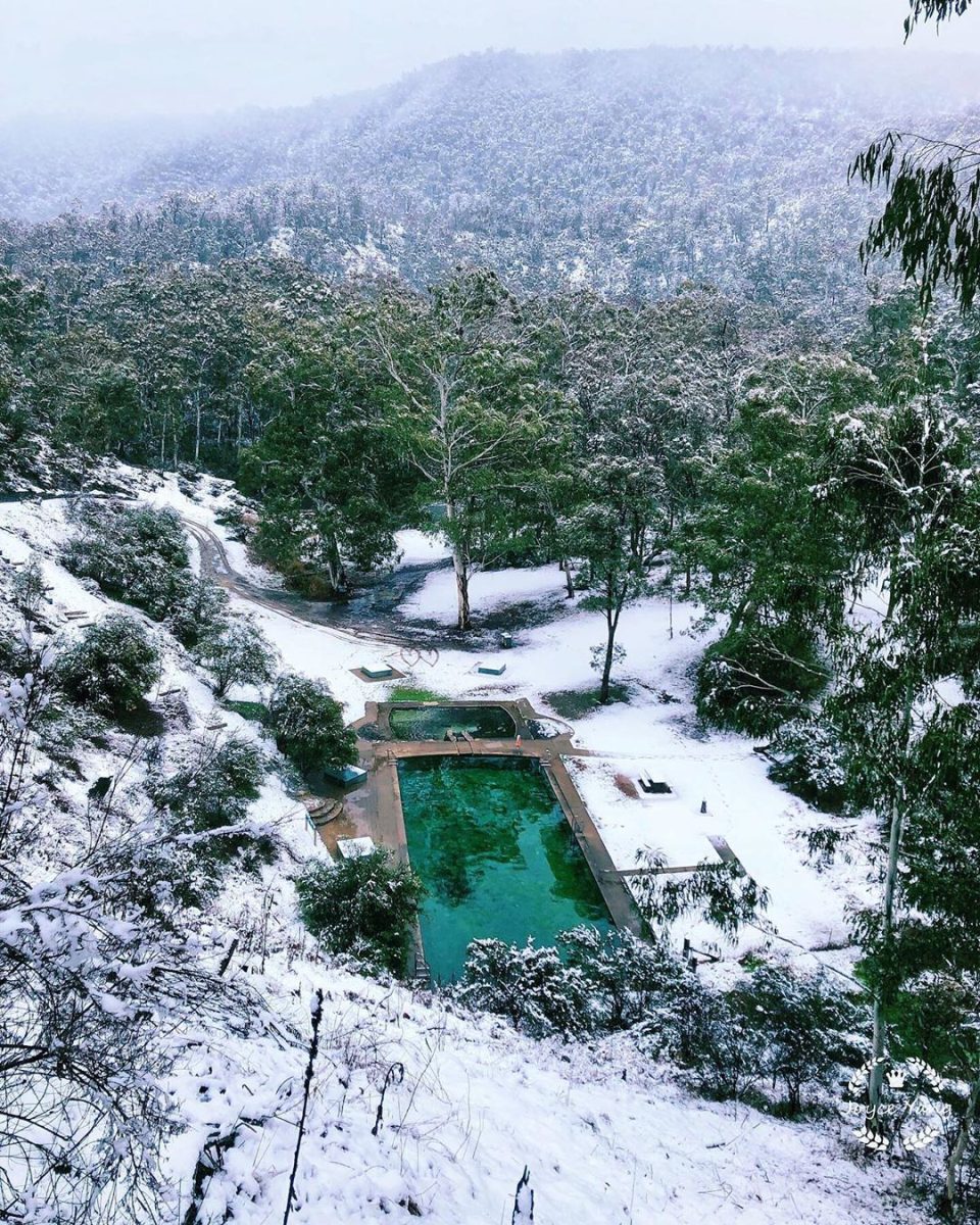 Yarrangobilly Caves geothermal pool surrounded by snow