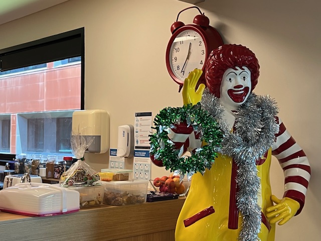 Ronald McDonald, the McDonalds mascot draped in Christmas decor