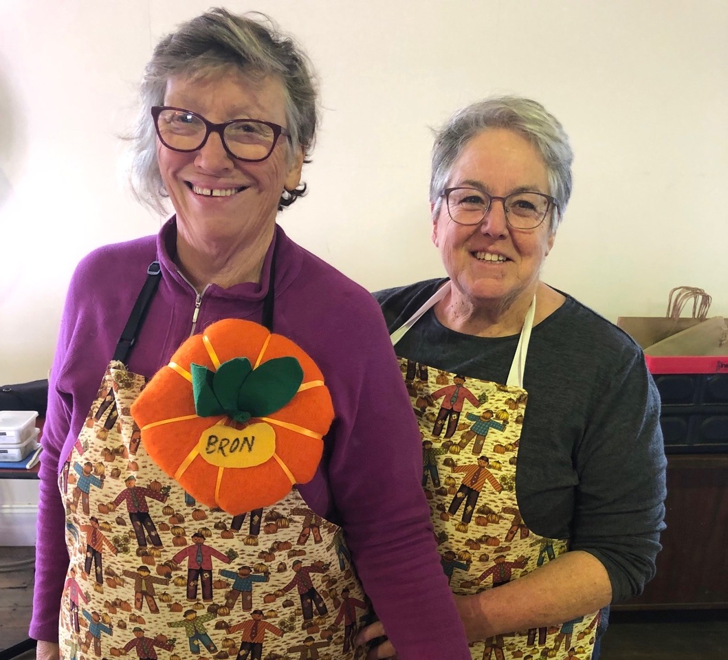 two women in aprons