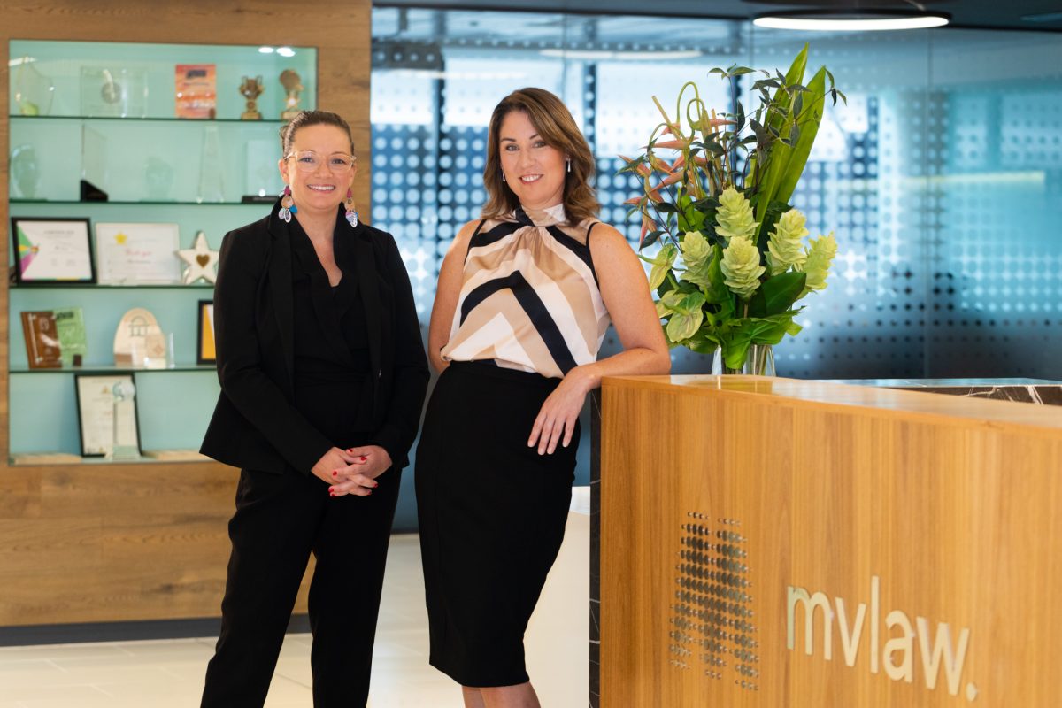 Two ladies standing at the office.