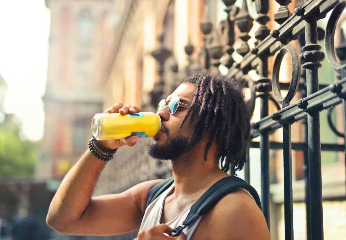 man drinking soft drink