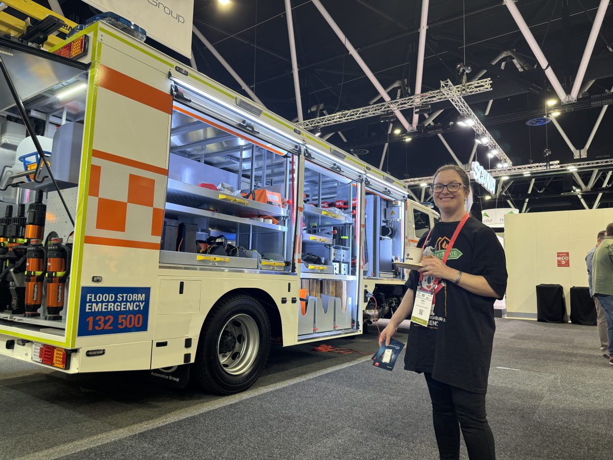 Resilience crusader Emily Karabatic in front of emergency vehicle