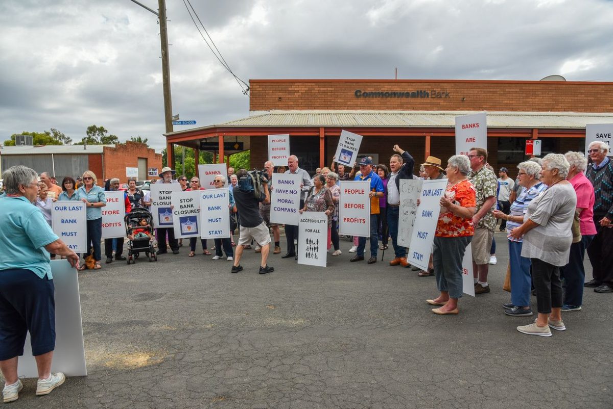 A group of people protesting on the street outside the bank in Junee