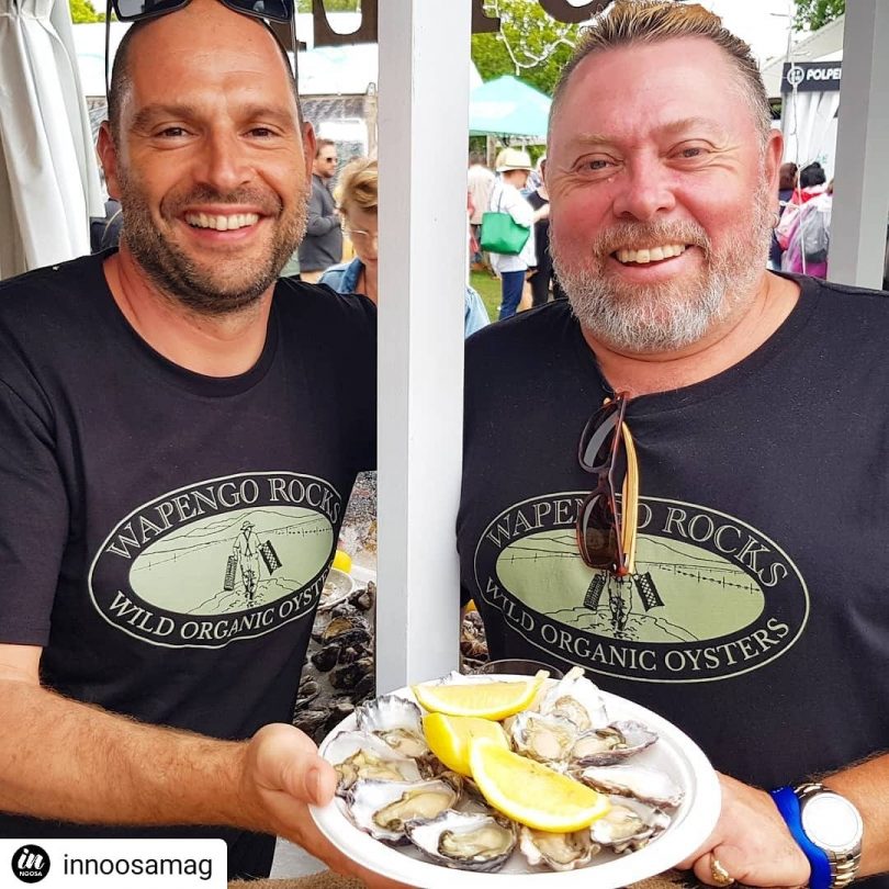 Oliver Shaw Carruthers (left) and oyster farmer Shane Buckley (right) holding plate of oysters.