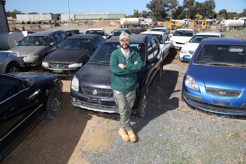 Ken Astrup with abandoned vehicles