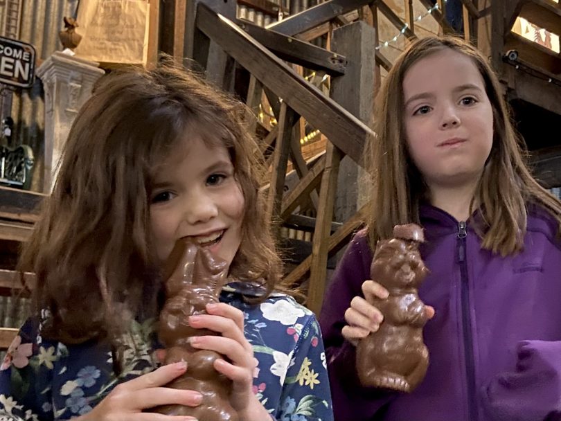 Girls eat chocolate rabbits