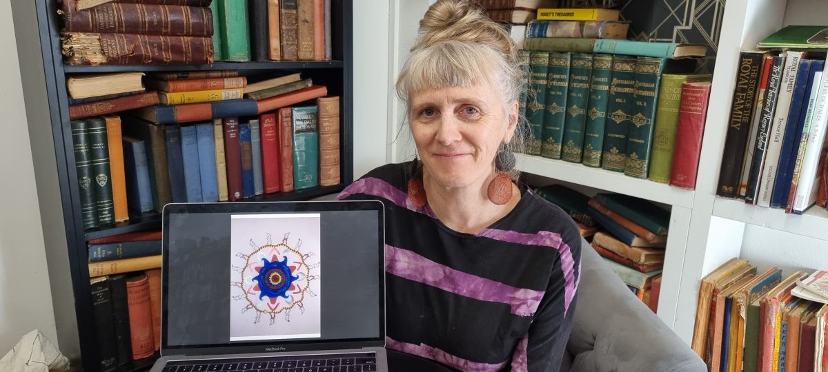 Friends of Wagga Wagga Art Gallery assistant Maryanne Gray holding laptop showing mandala art