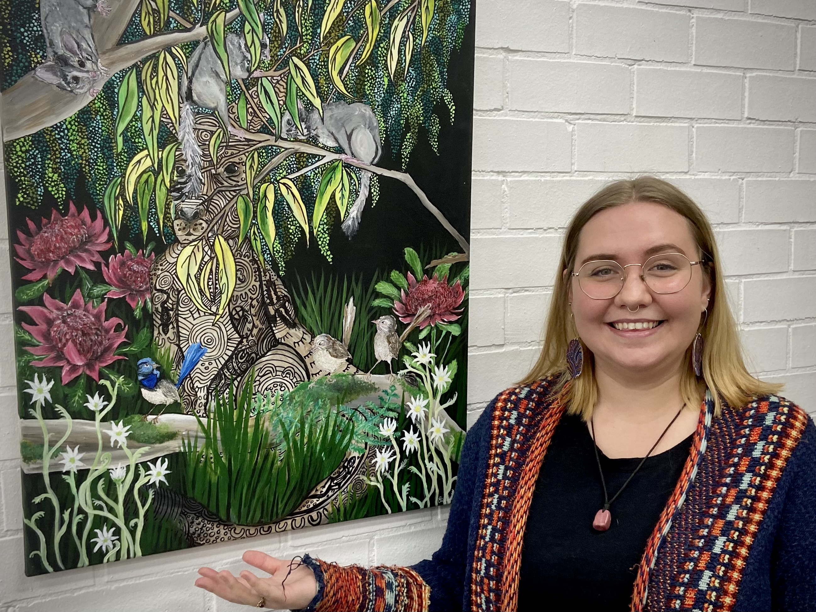 Wiradjuri artist Elizabeth Doherty with her painting at the Curious Rabbit in Wagga Wagga