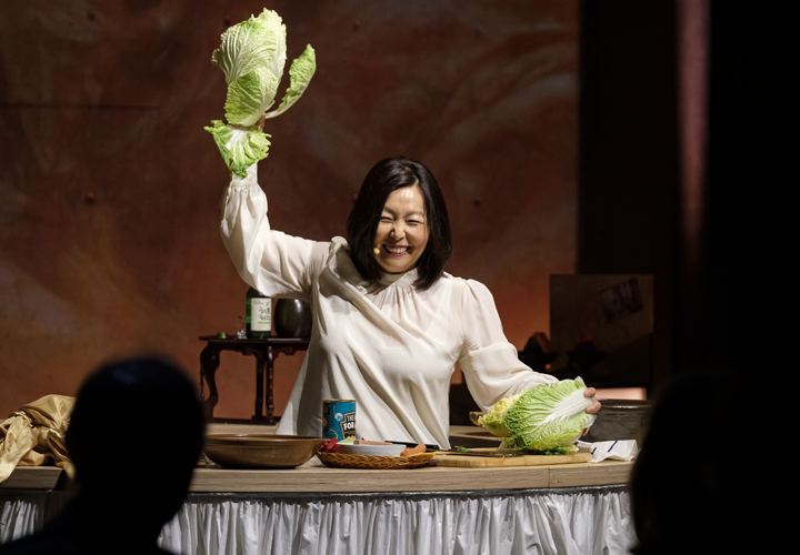 Woman holding up a vegetable