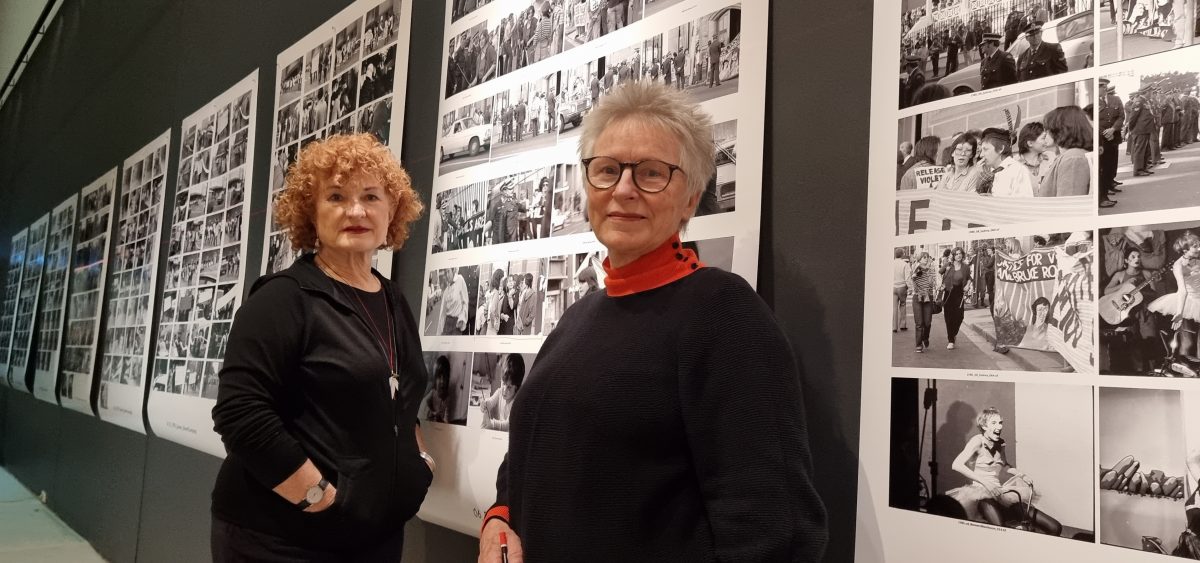 Julie Ewington and Helen Grace in front of photos