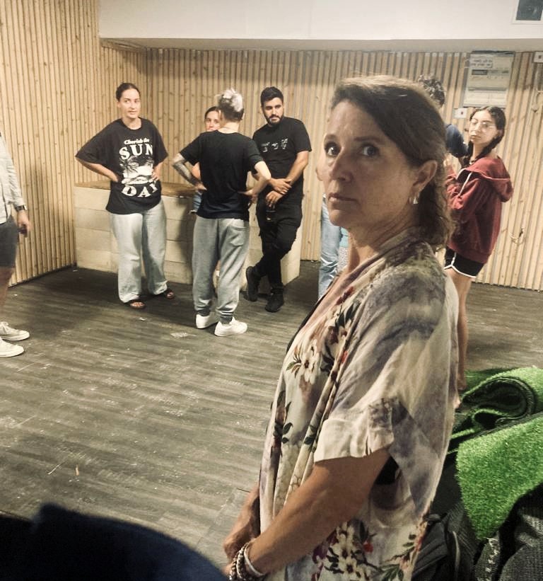 Woman, with people in the background, in a safe room in Tel Aviv