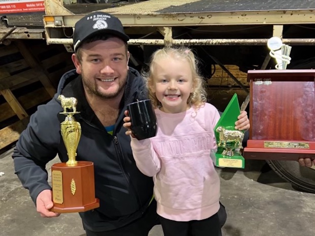 Bailey O’Rafferty, a prolific winner of quick shear competitions in NSW including Binda, with his daughter Gracie. 