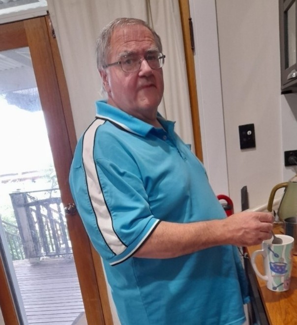 A man in a blue shirt and glasses