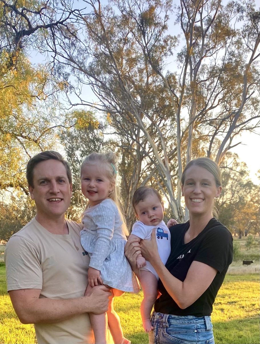 man and woman holding their two kids