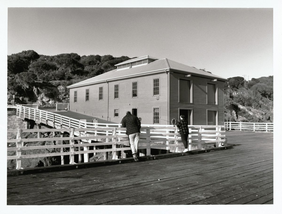 Men standing on wooden wharf