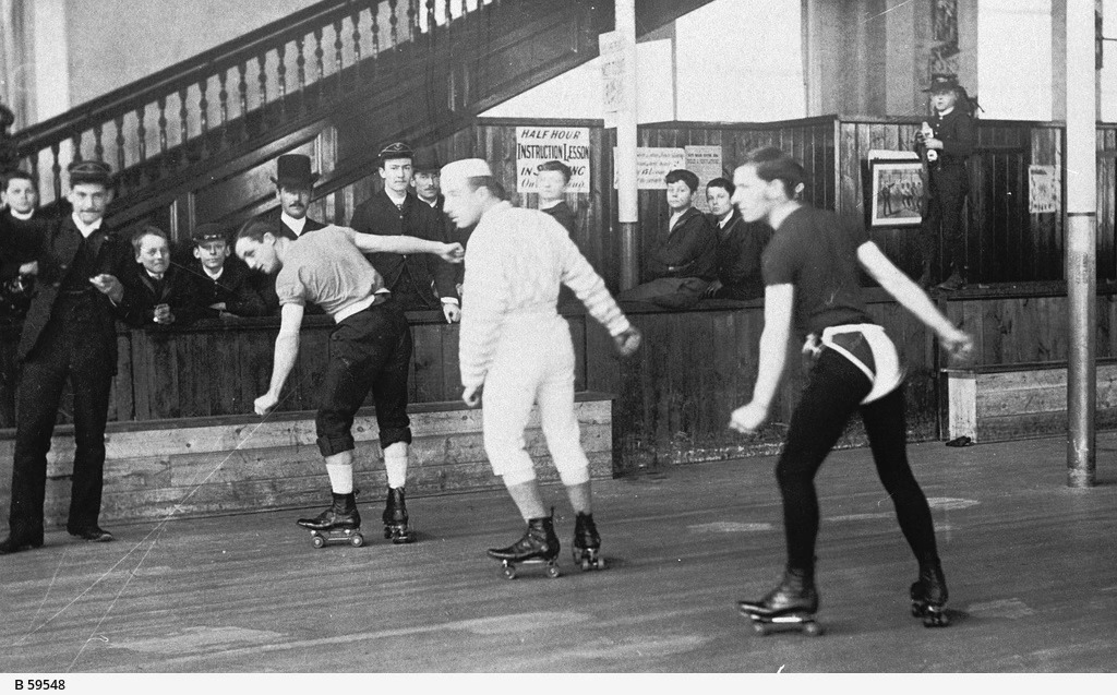 Historical photo of men on roller skates.