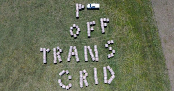 NSW farmer creates hay bale sign to protest against powerline project