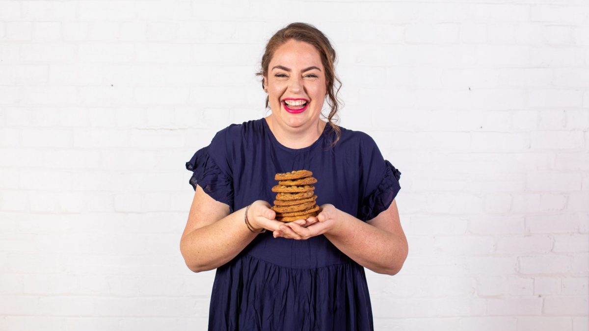 Woman holding biscuits.