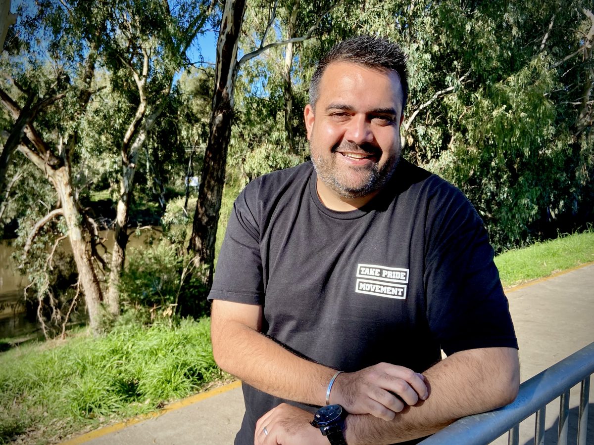 Comedian Dane Simpson standing by the river