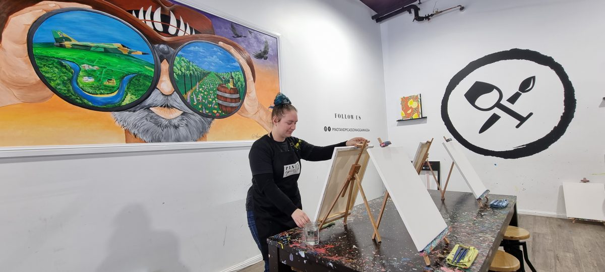Rhiannan Lee Hollister painting in the Wagga Pinot and Picasso studio