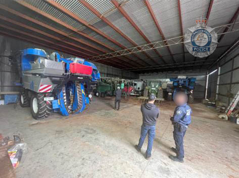 police officers in farm shed