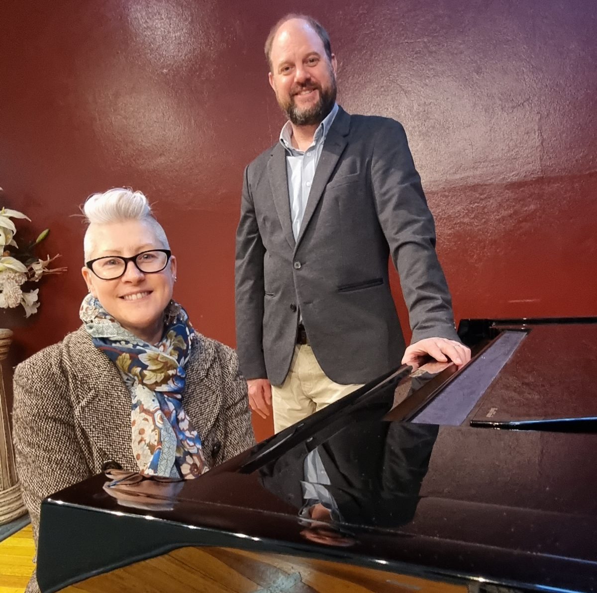 Kara Williams with RCM's CEO Hamish Tait at a piano