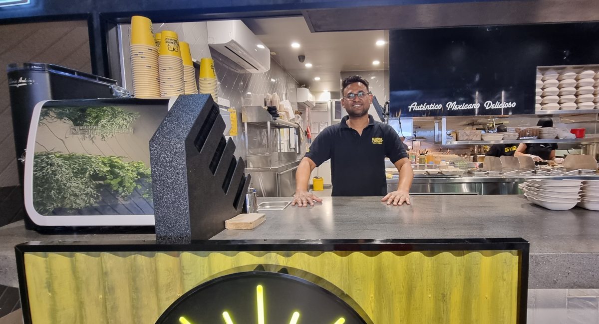 Guzman y Gomez Wagga owner Asif Ahmed behind the counter