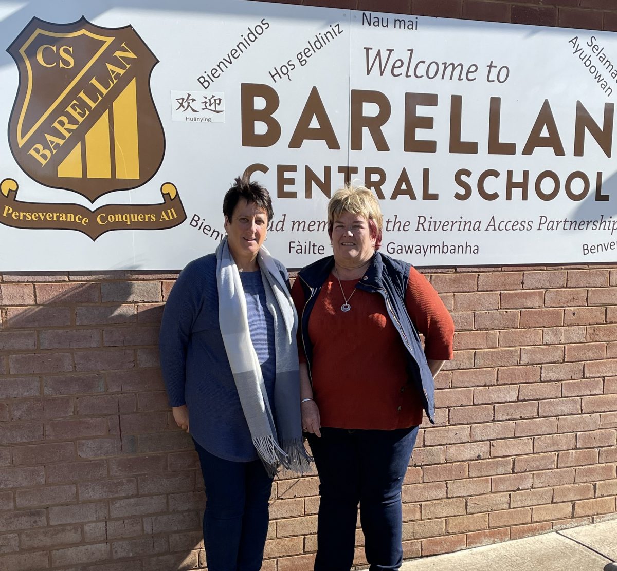 Sue Flagg and Allison Prentice stand in front of the Barellan Central School sign