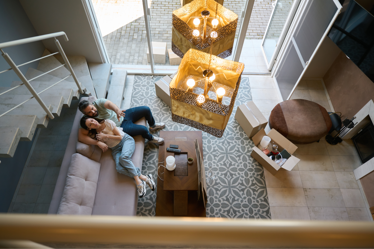 birds eye view of two people sitting on a couch in a lounge room