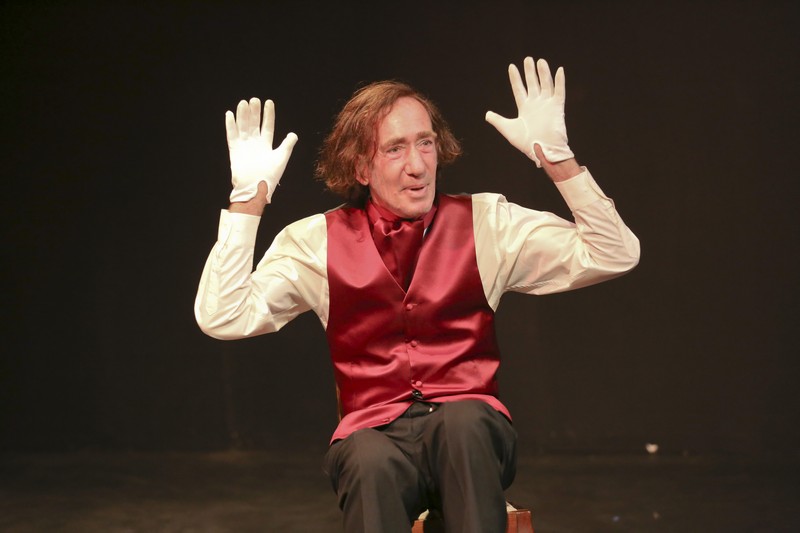 Man on stage miming