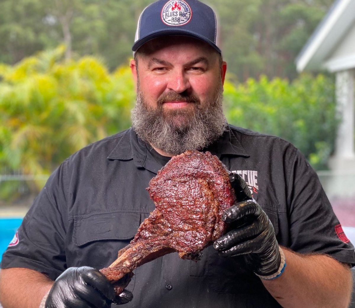 Adam Roberts holding barbecued steak