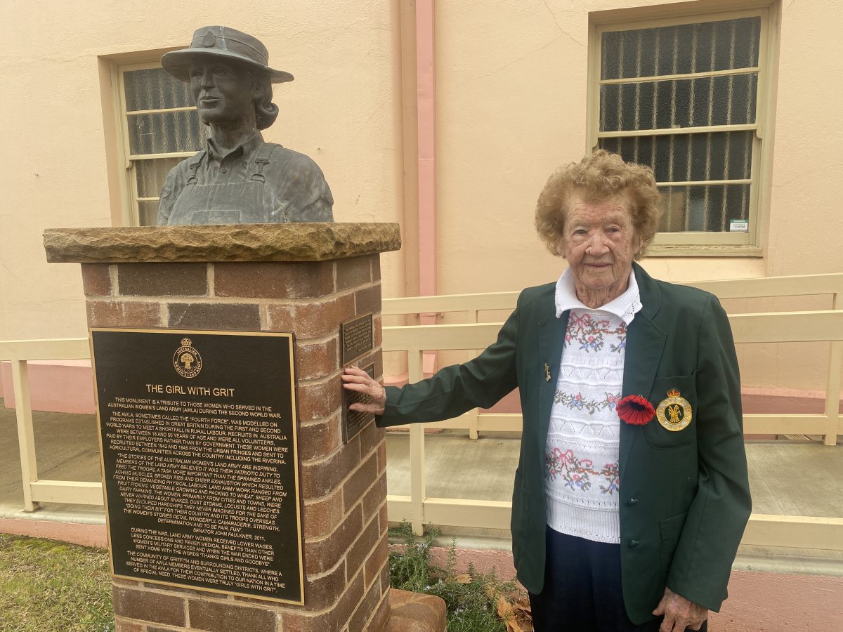 Kathleen Savage next to monument