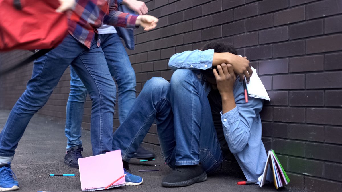 Male youth being attacked by two others