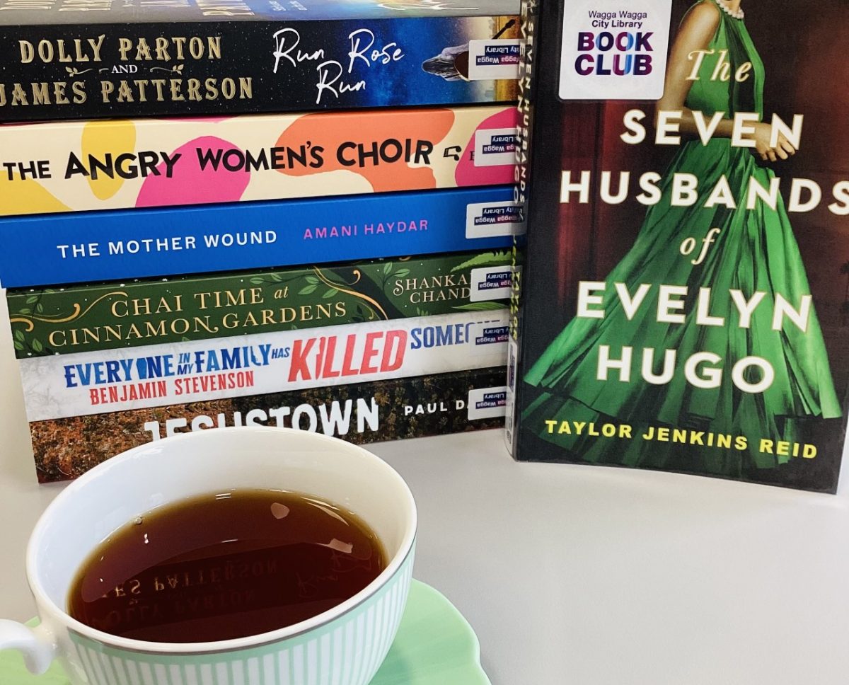 Cup of tea next to stack of books