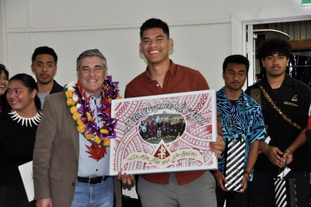 Pacific Island student holds a farewell gift. 