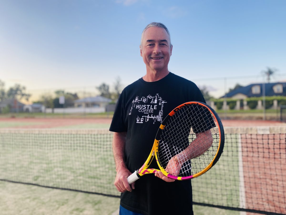Stephen Munro with a tennis racquet