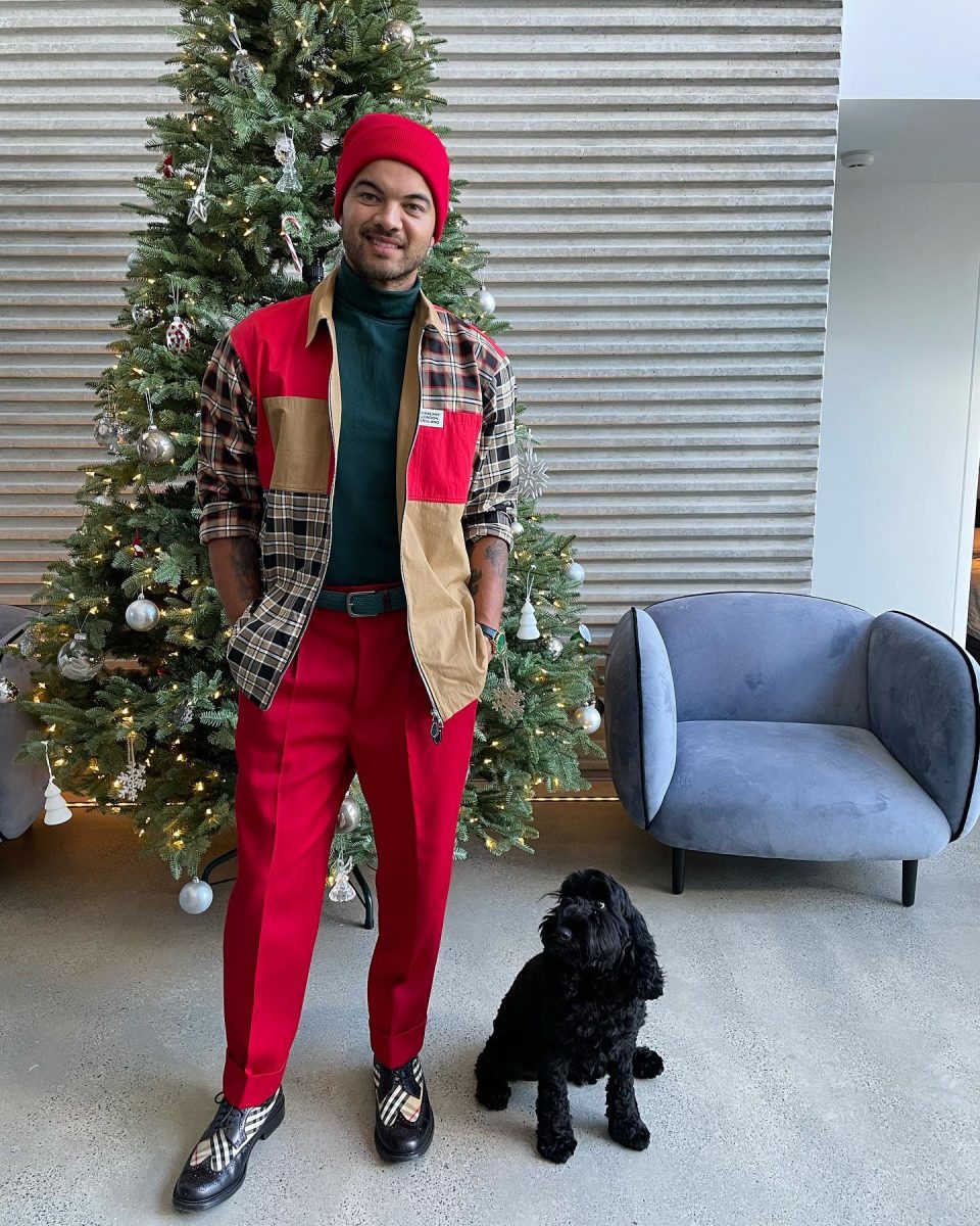 Guy Sebastian in front of a Christmas tree