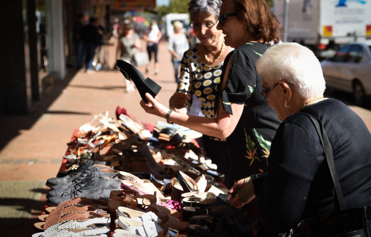 People look at shoes at the Griffith Sidewalk Sale 