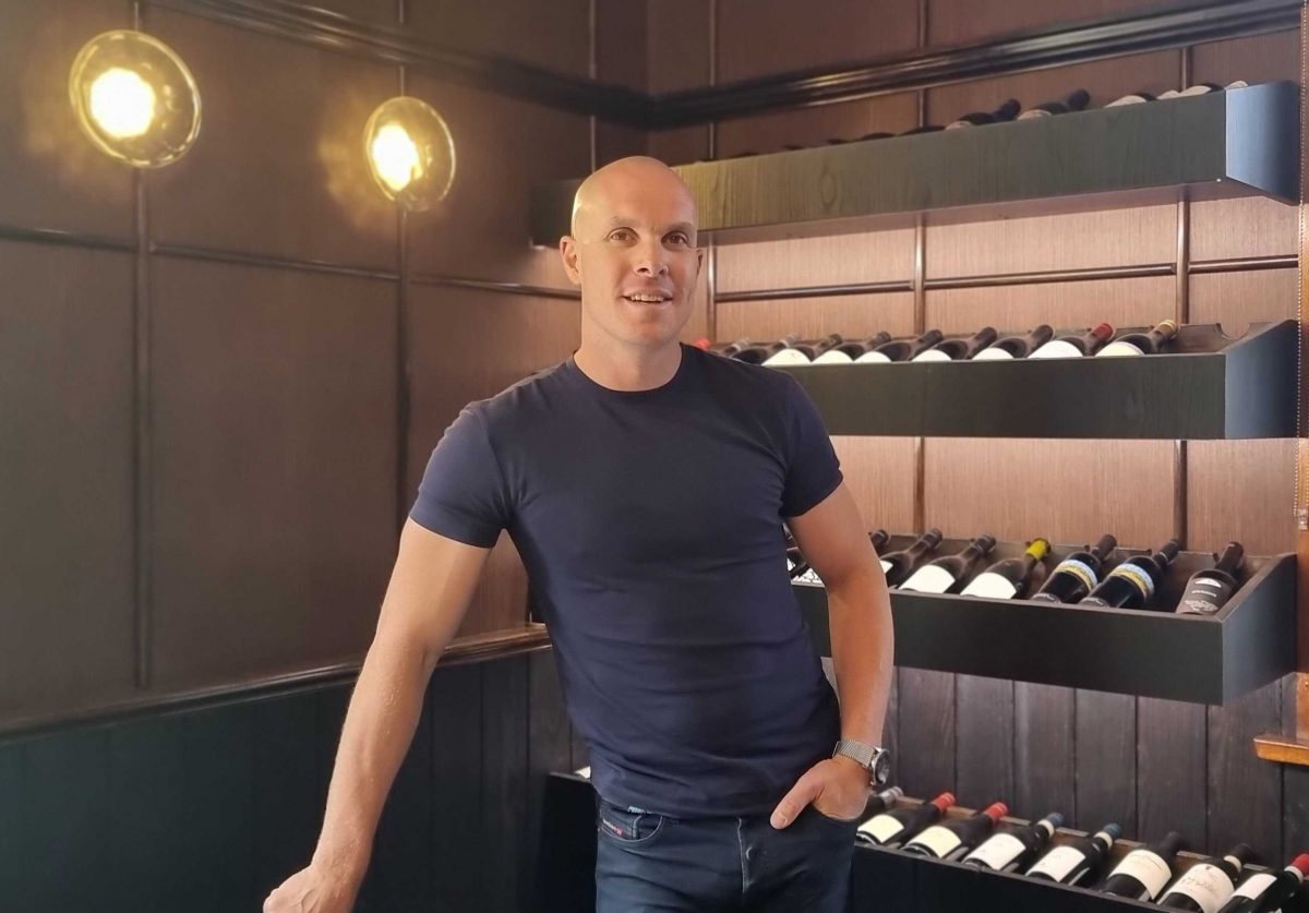 man standing in wine cellar