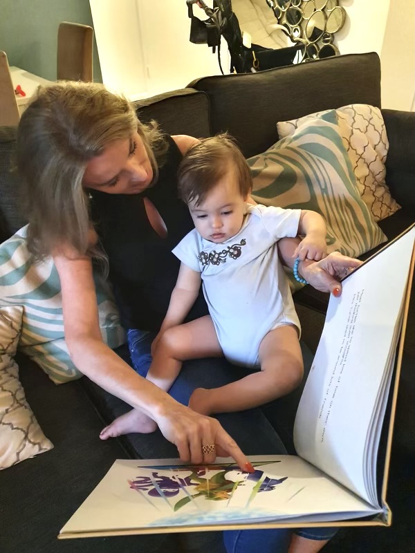 Julia Hopp reading her book to her grandson