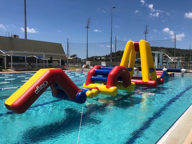 Giant inflatable obstacle course in a pool
