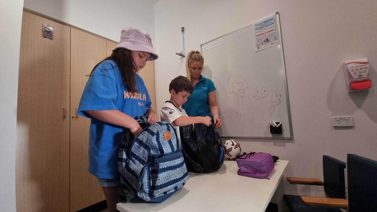 kids being shown how to pack school bags