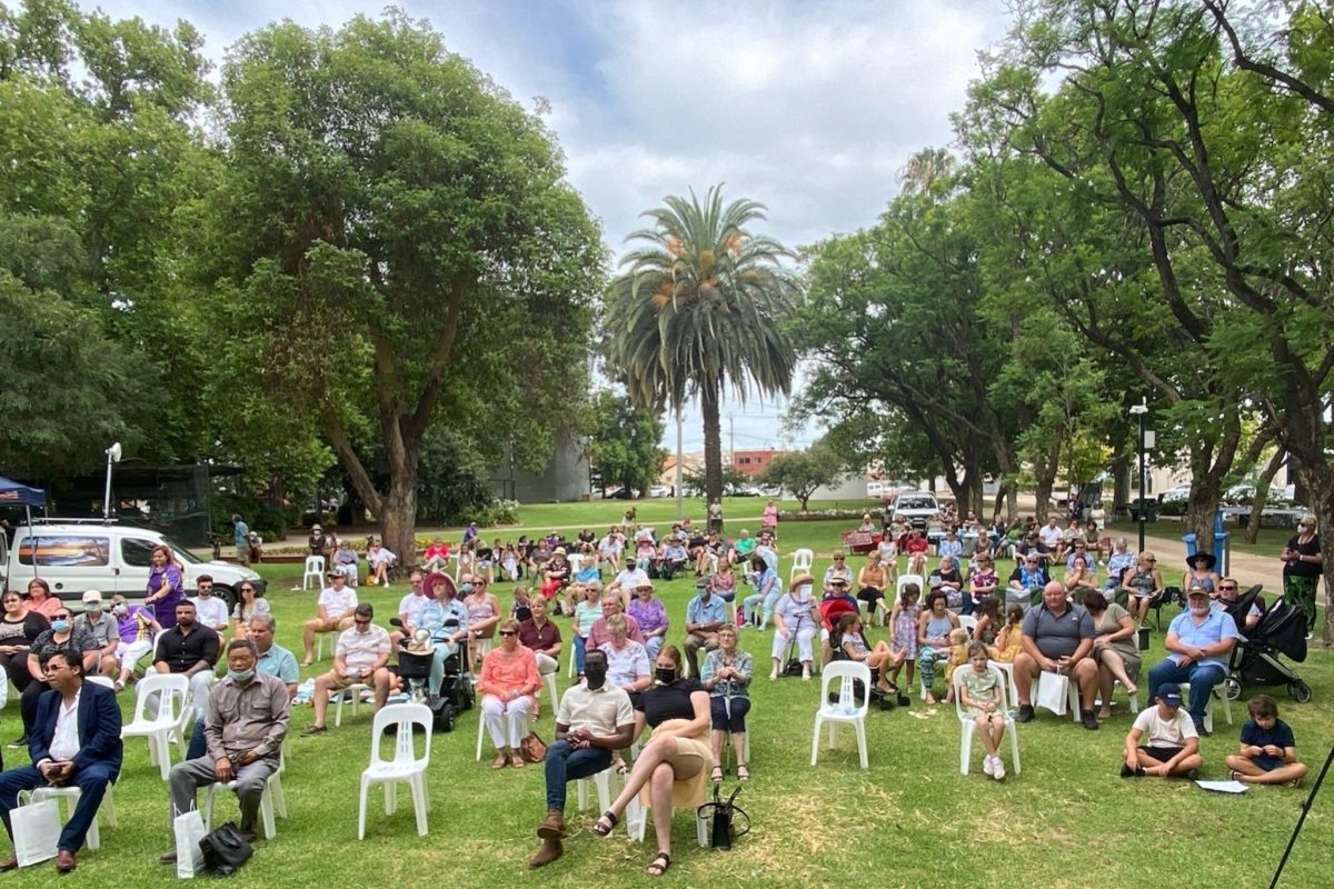 Crowd seated in a park