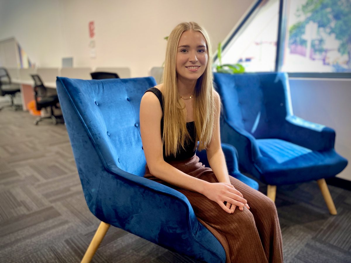 Tilly Ryan seated in a blue chair
