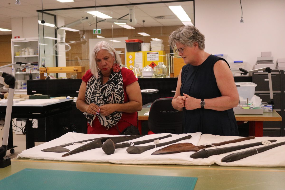 two women with Aboriginal artefacts