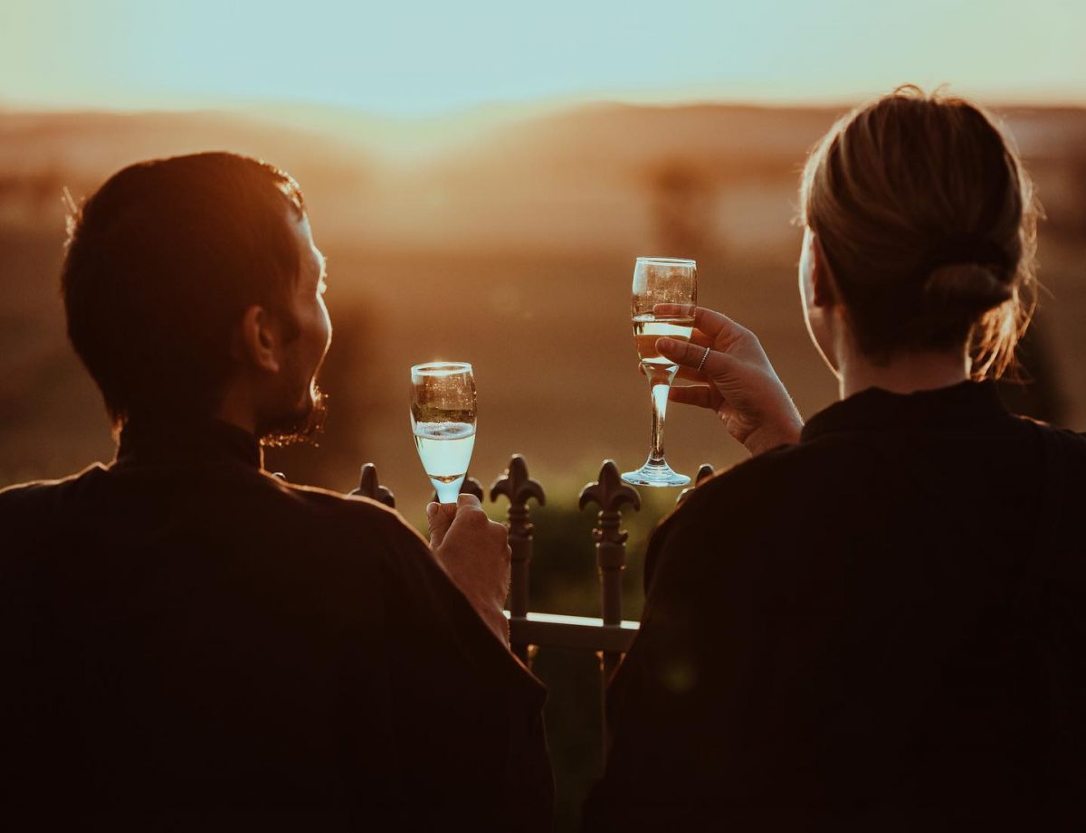 two people drinking wine