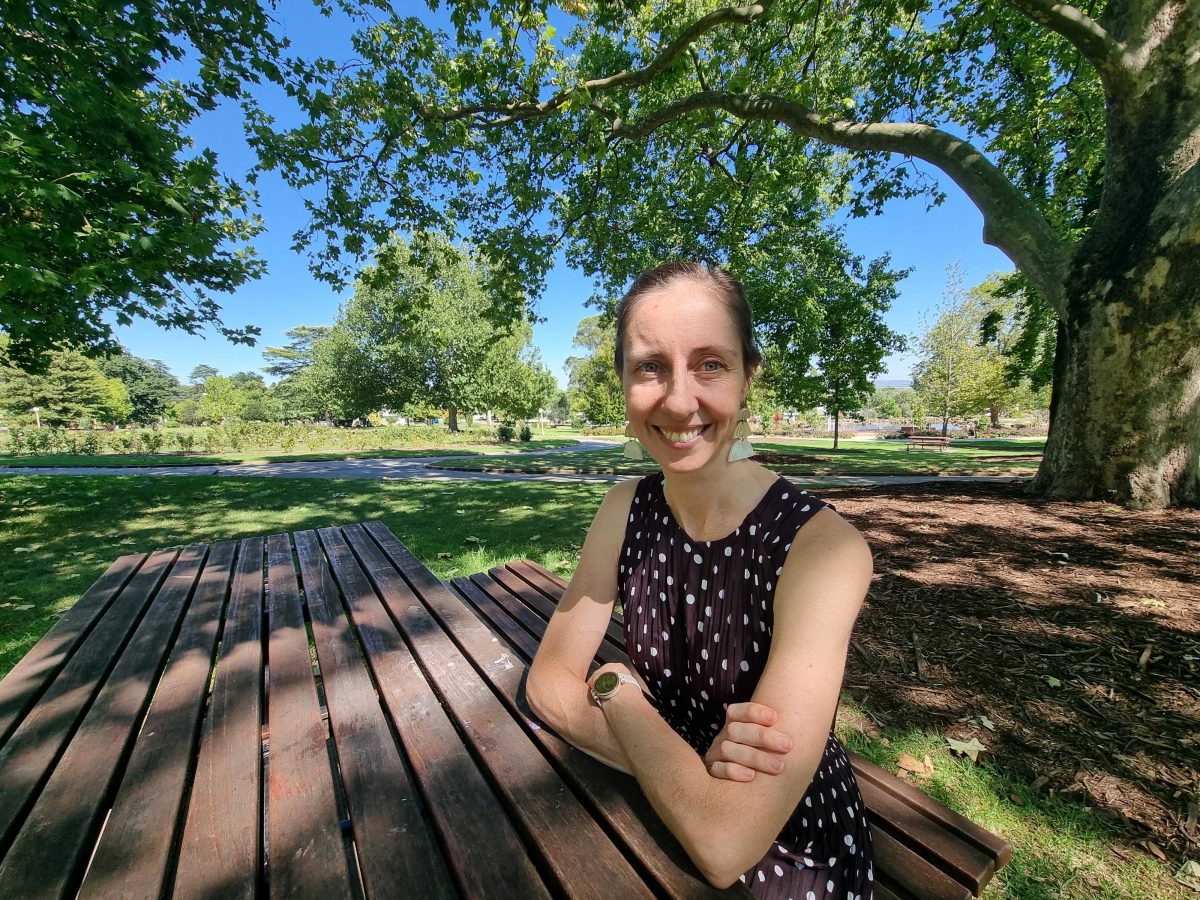 woman sitting at park table