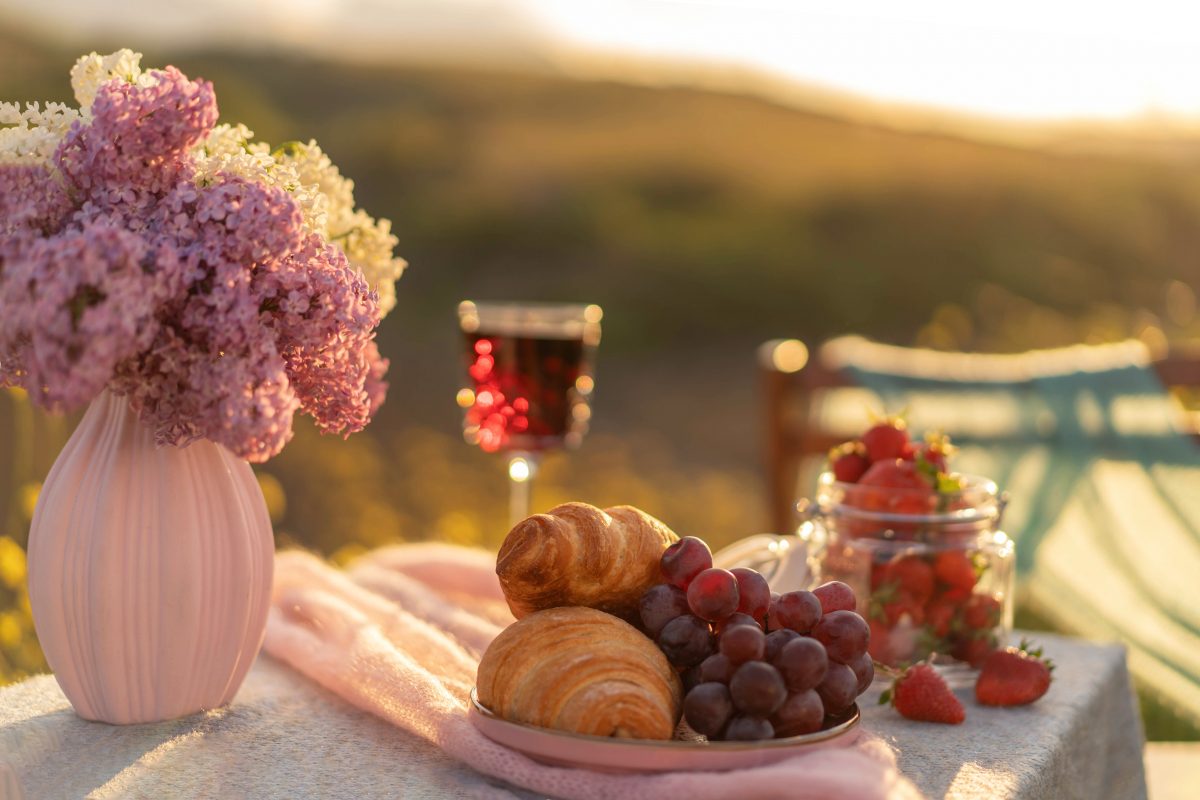 Croissants and grapes with countryside in the background